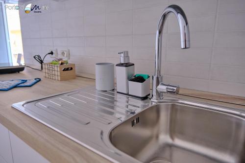 a kitchen sink with a faucet on a counter at Porto d'aMare - Rooms in Porto Recanati
