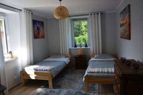 A bed or beds in a room at Gęsia Sielanka