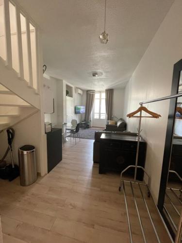 a living room with a staircase and a living room with a floor at Apartment on Dante street next to the sea in Nice