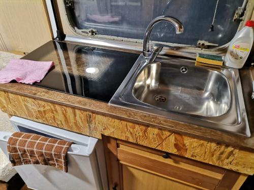 a kitchen with a sink and a counter at Green Garden Caravan in Zakynthos
