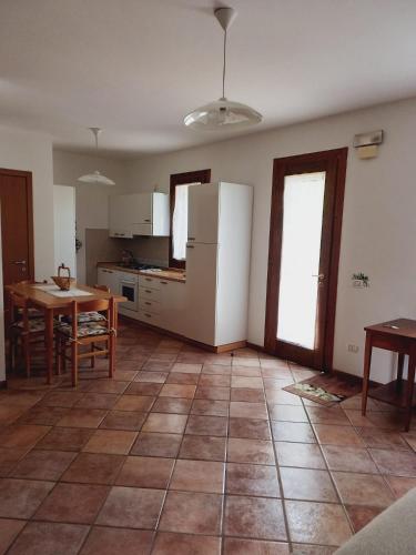 a large kitchen with a table and a kitchen with a table and a tablektop at Green Nest in Farra di Soligo