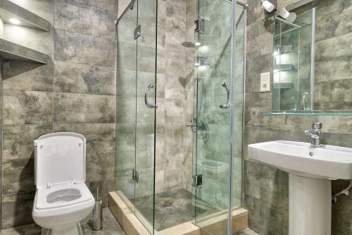 a bathroom with a shower and a toilet and a sink at Q&B House in Tbilisi City