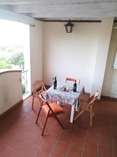 a table and chairs in a room with a window at Casa Vacanza Libone in Nova Siri Marina