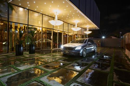 a car parked in front of a building at night at Number One Oxford Street Hotel & Suites in Accra