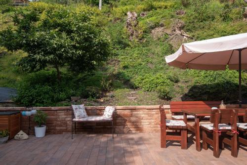 a patio with a table and chairs and an umbrella at Chalupa 246 in Vrchlabí
