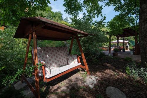 a bench in a gazebo in a yard at Chalupa 246 in Vrchlabí