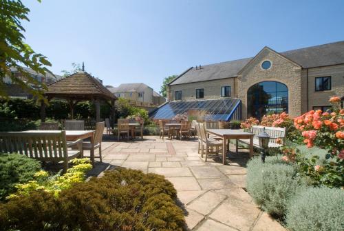 a patio with tables and chairs and a gazebo at Best Western Plus Angel Hotel in Chippenham