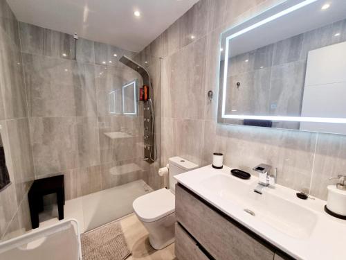 a bathroom with a sink and a toilet and a tub at Luxury Zen Puerto Del Carmen in Puerto del Carmen