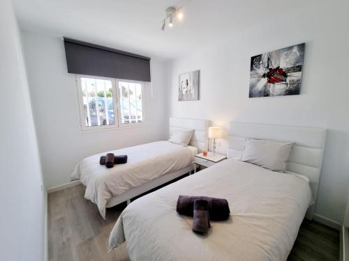 a bedroom with two beds and a window at Luxury Zen Puerto Del Carmen in Puerto del Carmen