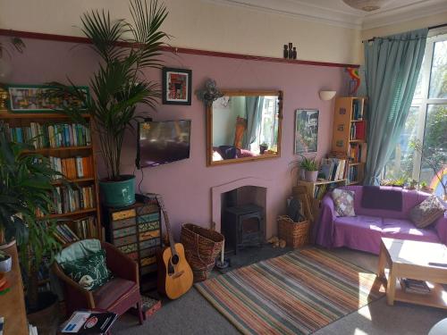 a living room with a couch and a fireplace at Falmouth Lodge in Falmouth