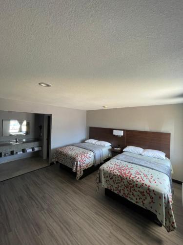 a hotel room with two beds in a room at Ridge Motel in Breckenridge