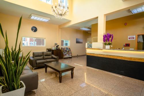 a waiting room with a couch and a table at Maywood Inn in Maywood
