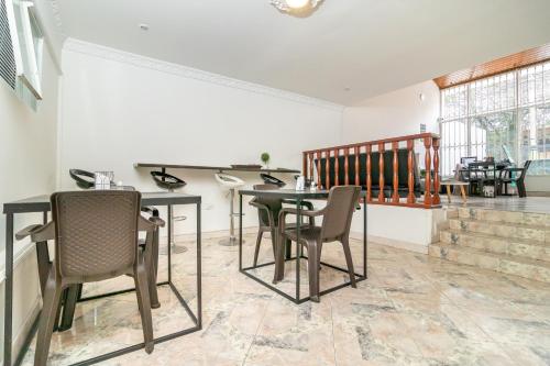 a dining room with a table and chairs at Hotel Quintas de Normandia in Bogotá