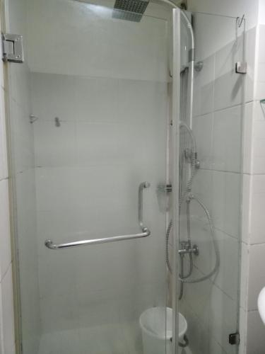 a shower with a glass door in a bathroom at SEA RESIDENCES F in Manila