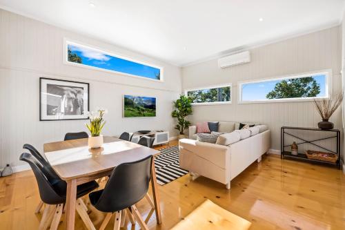 a living room with a table and a couch at Bluestone Cottages - The Shop in Toowoomba
