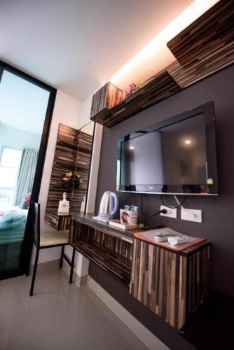 a room with a large television on a wall at 48 Metro Hotel in Bangkok