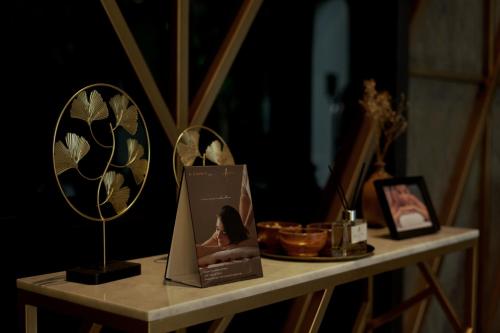 a table with two mirrors and a book on it at Awann Sewu Boutique Hotel and Suite Semarang in Semarang