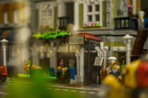 a lego model of a city with a man sitting under a bus stop at Awann Sewu Boutique Hotel and Suite Semarang in Semarang