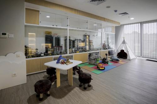 a room with a table and some toy animals on the floor at Awann Sewu Boutique Hotel and Suite Semarang in Semarang