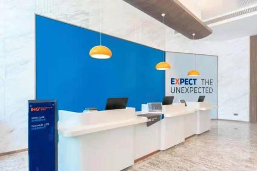 an office with a sign that reads expect the unexpected at Holiday Inn Express Xining Railway Station by IHG in Xining