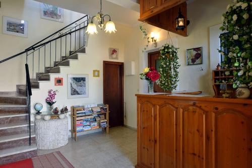 a living room with stairs and a stair case at Eleni Apartments in Roda