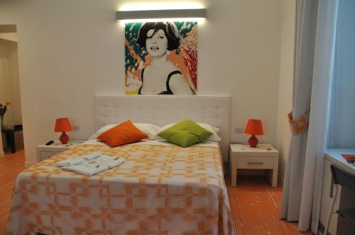 a bedroom with a bed with a painting of a woman at Divine Bed & Breakfast in Rome