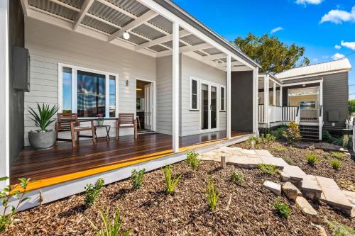 a deck with a pergola on a house at Bluestone Cottages - The Villa in Toowoomba