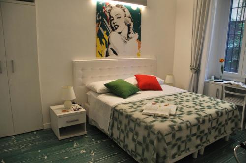 a bedroom with a bed and a painting on the wall at Divine Bed & Breakfast in Rome