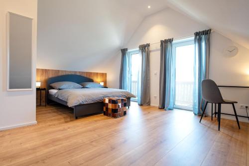 a bedroom with a bed with blue pillows at Ferienhaus Megumi in Siegsdorf