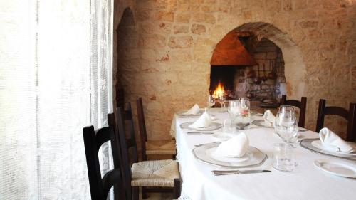 a table with white plates and napkins on it at Tenuta Monacelle in Selva di Fasano