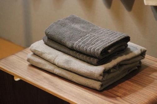 a pile of towels sitting on top of a table at Ikebukuro Apartment in Tokyo