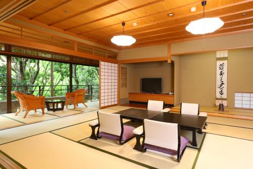 a dining room with a table and chairs at Oku Yugawara SANSUIROU in Yugawara