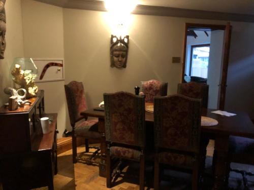 a dining room with a table and chairs at South Lodge House in Dormans Land