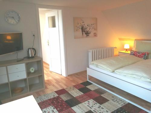 a bedroom with a bed and a television and a table at 4-Zimmer Haus in Leipzig in Leipzig