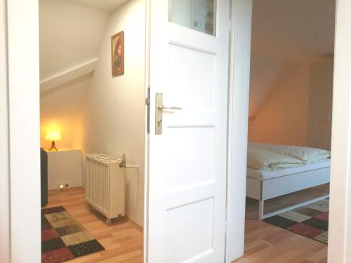 a door leading to a bedroom with a bed at 4-Zimmer Haus in Leipzig in Leipzig