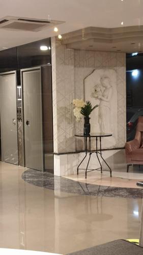 a vase of flowers on a table in a lobby at Esperia in Thessaloniki