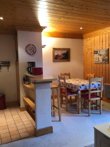 a kitchen with a table and chairs in a room at Le Tremplin in Méribel