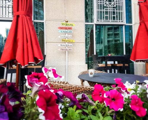 a table and chairs and flowers in front of a building at Ramada by Wyndham Downtown Dubai in Dubai