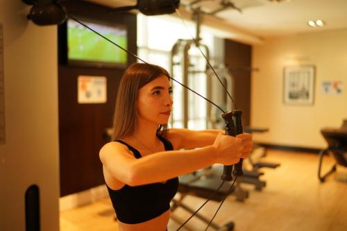 a woman holding a bow in a recording studio at Ramada by Wyndham Downtown Dubai in Dubai