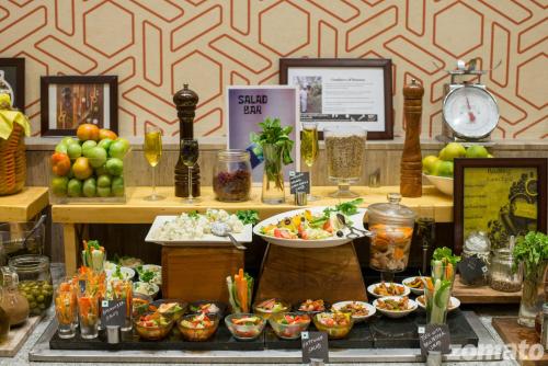 a display of food on a counter in a store at Novotel Chennai OMR in Chennai