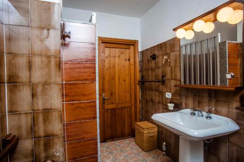 a bathroom with a sink and a shower and a toilet at Appartamento Piano terra in Sarroch