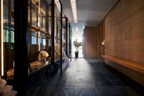 a hallway of a building with a display case at Tassel Hotel Sanjo Shirakawa in Kyoto