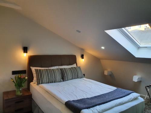 a bedroom with a large bed with a skylight at Hotel Hötorget in Stockholm
