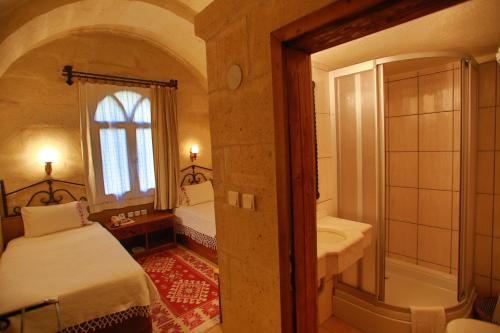 a bedroom with a bed and a sink and a tub at Hotel Surban - Special Category in Ürgüp