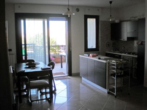 une cuisine avec une table et une cuisine avec une salle à manger dans l'établissement Casa Vacanze Montesilvano, à Montesilvano