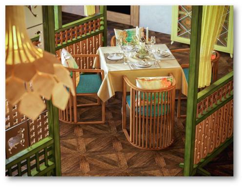 a table in a restaurant with a table and chairs at Radisson Blu Resort Visakhapatnam in Visakhapatnam