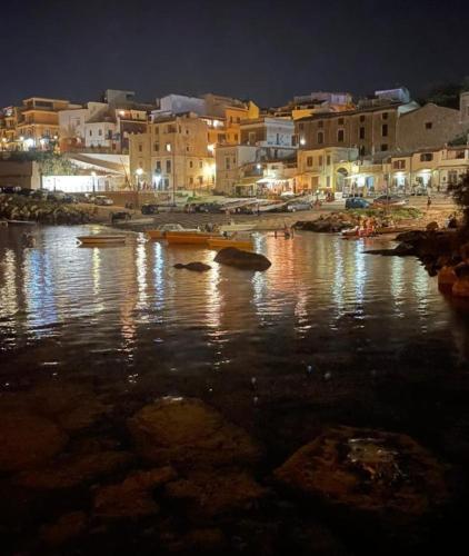 a group of boats in the water at night at Summer Dream LA CASA SUL MARE in Trappeto