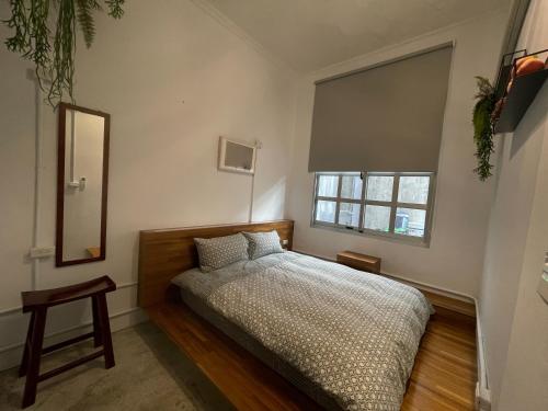 a bedroom with a bed and a window at Shen Nong Village in Yilan City