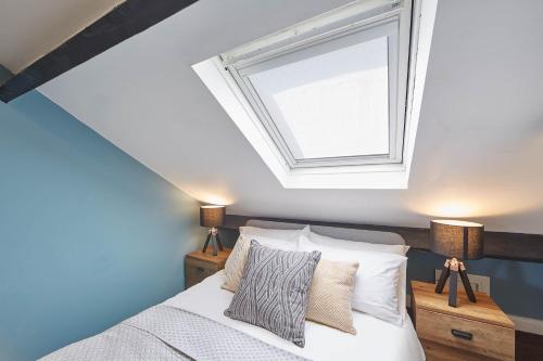 a bedroom with a bed and a skylight at Host & Stay - The Loft in Whitby