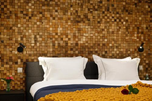 a bedroom with a bed and a brick wall at LOFT 188 Luxury Apartment Hotel in Utrecht